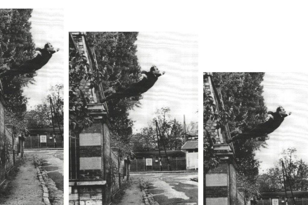 A photo of a man leaping from a roof.