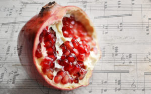 split pomegranate on music scale sheet