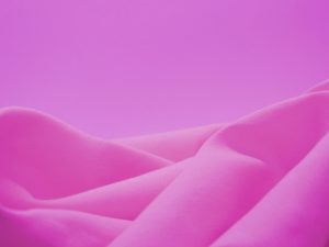 Pink fabric piled against a pink background.