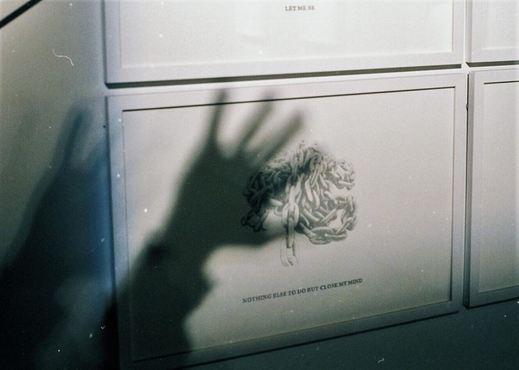 Grey cabinet with shadow of hand on its surface