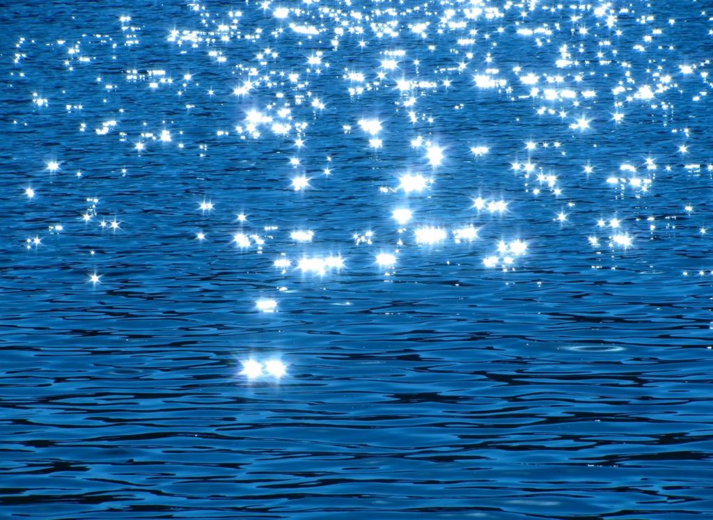 Blue water surface sparkling in the sun