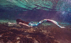 Photo depicting a mermaid underwater