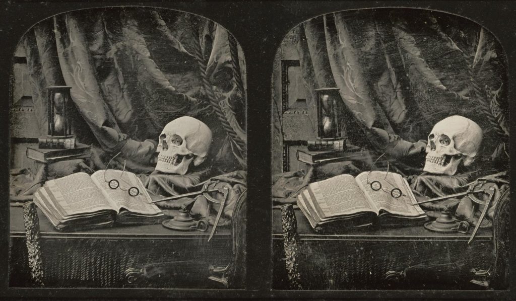 Art depicting a skeleton and an open book