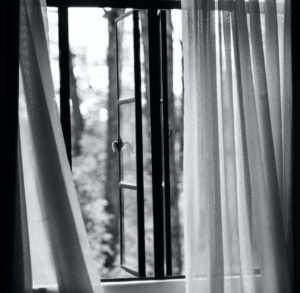 Open window with white curtains